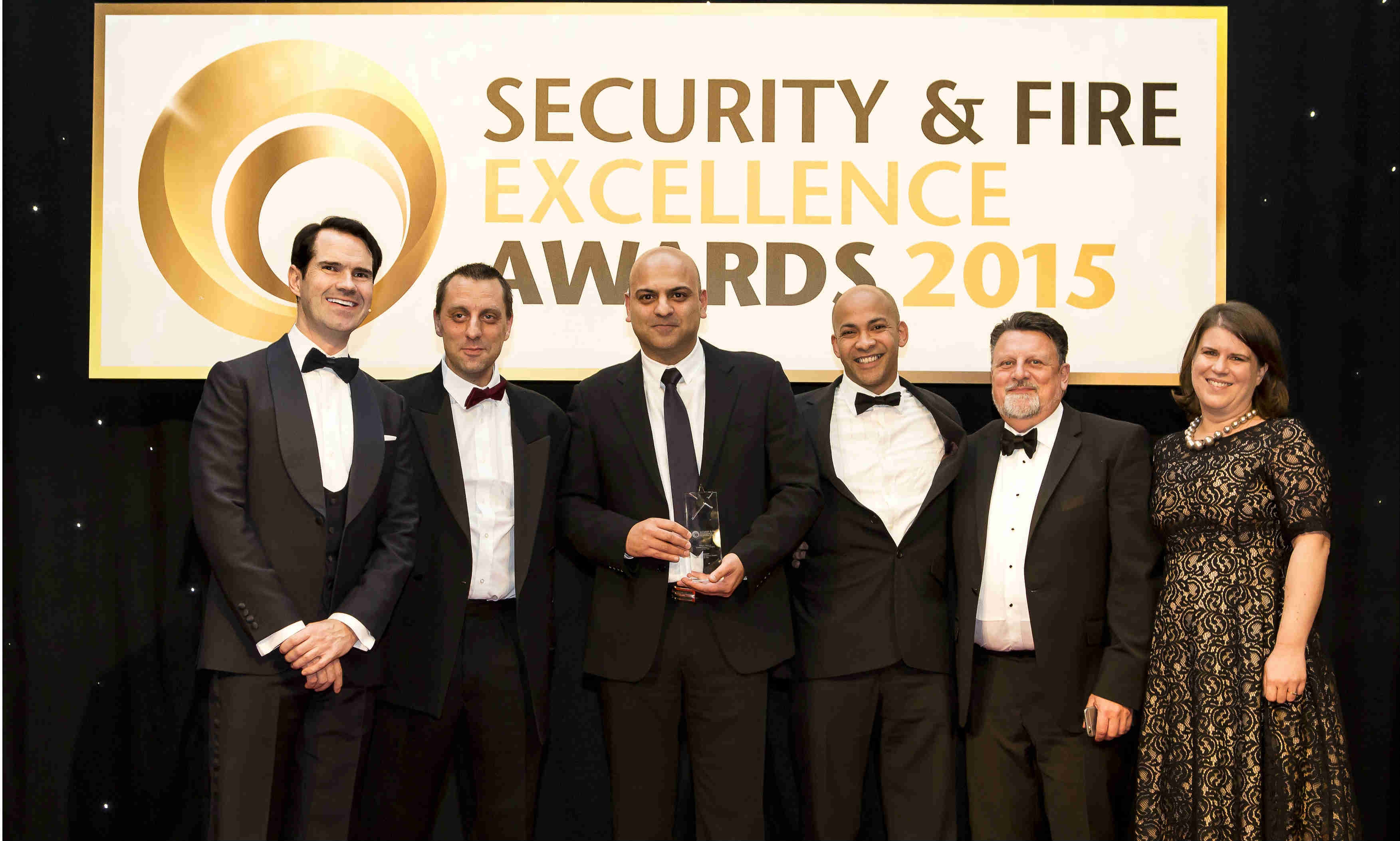 Paul Singh, Y3K’s Group CEO, accepts the award alongside Jimmy Carr at this year’s Security & Fire Excellence Awards